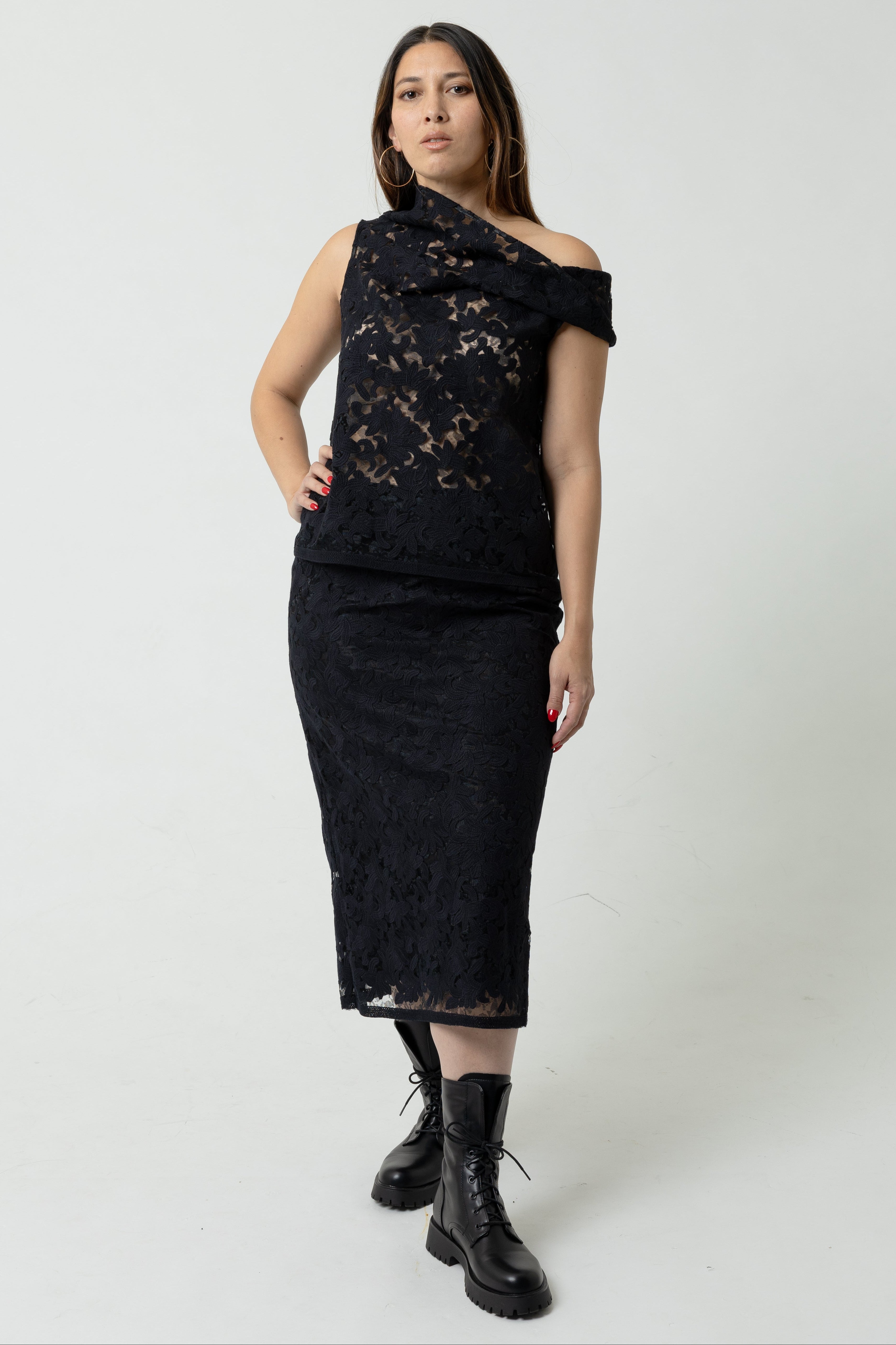 Woman wearing a black lace dress on a white background