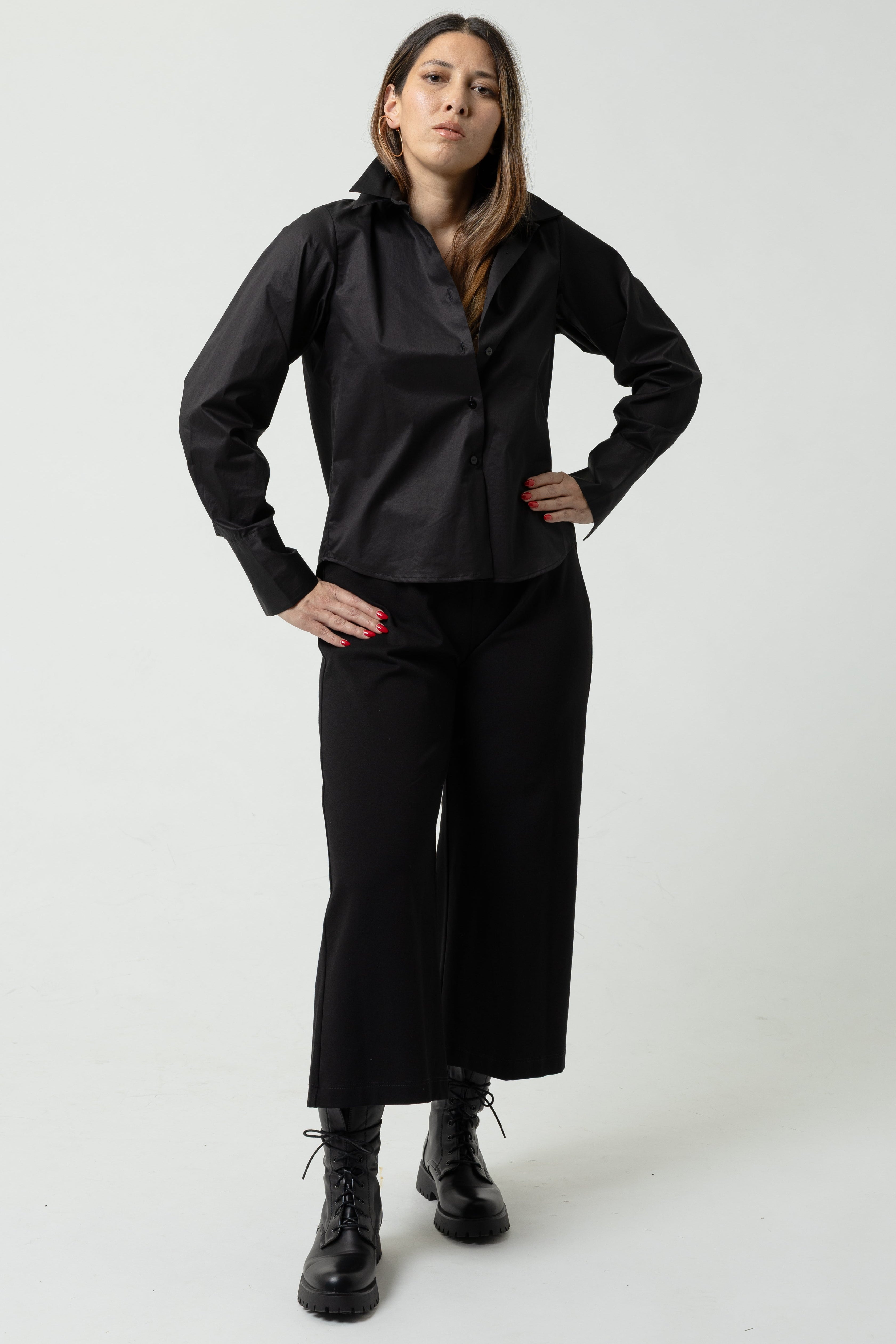Person wearing a black outfit on a white background