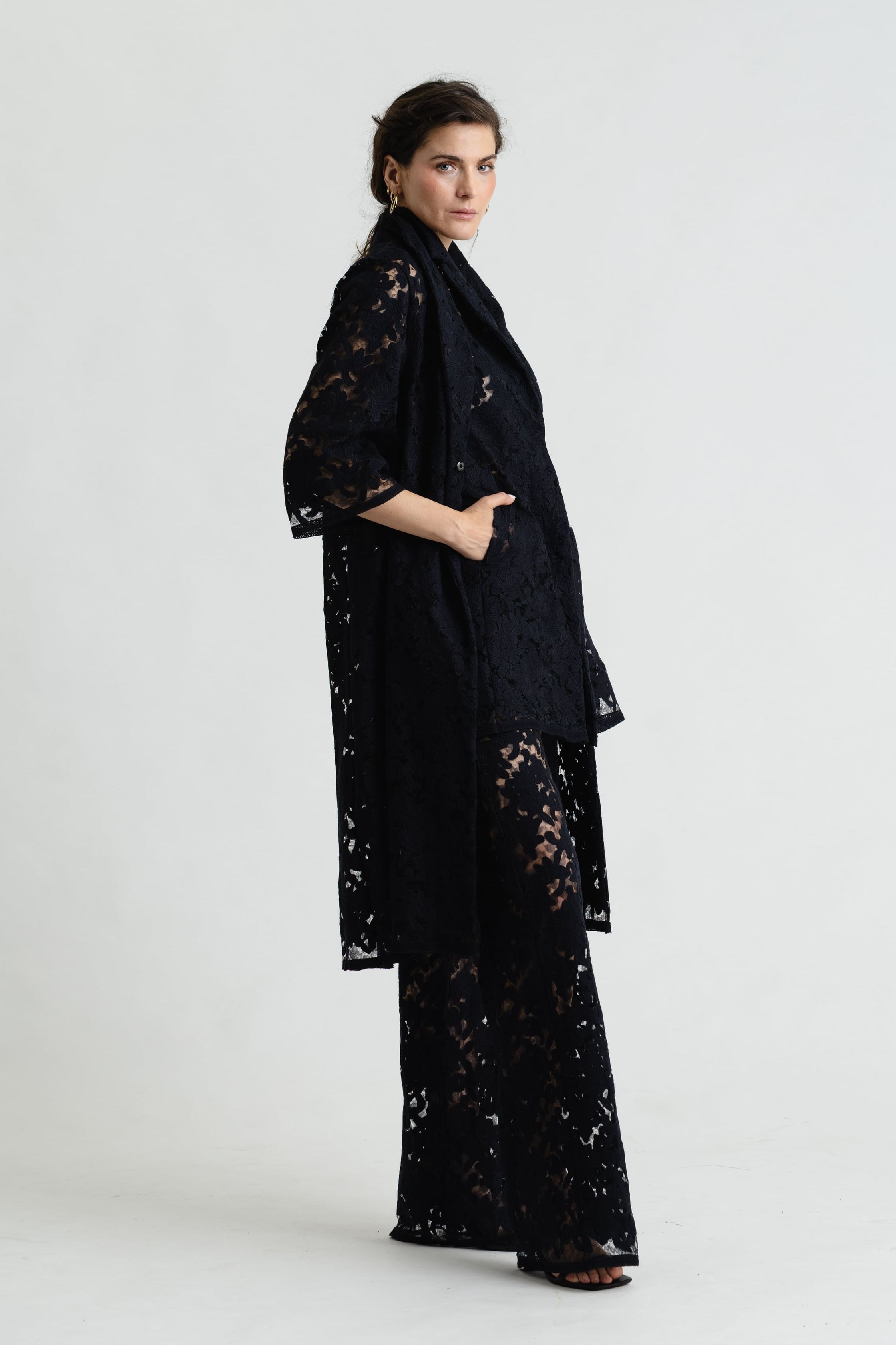 Woman wearing a black lace outfit on a white background