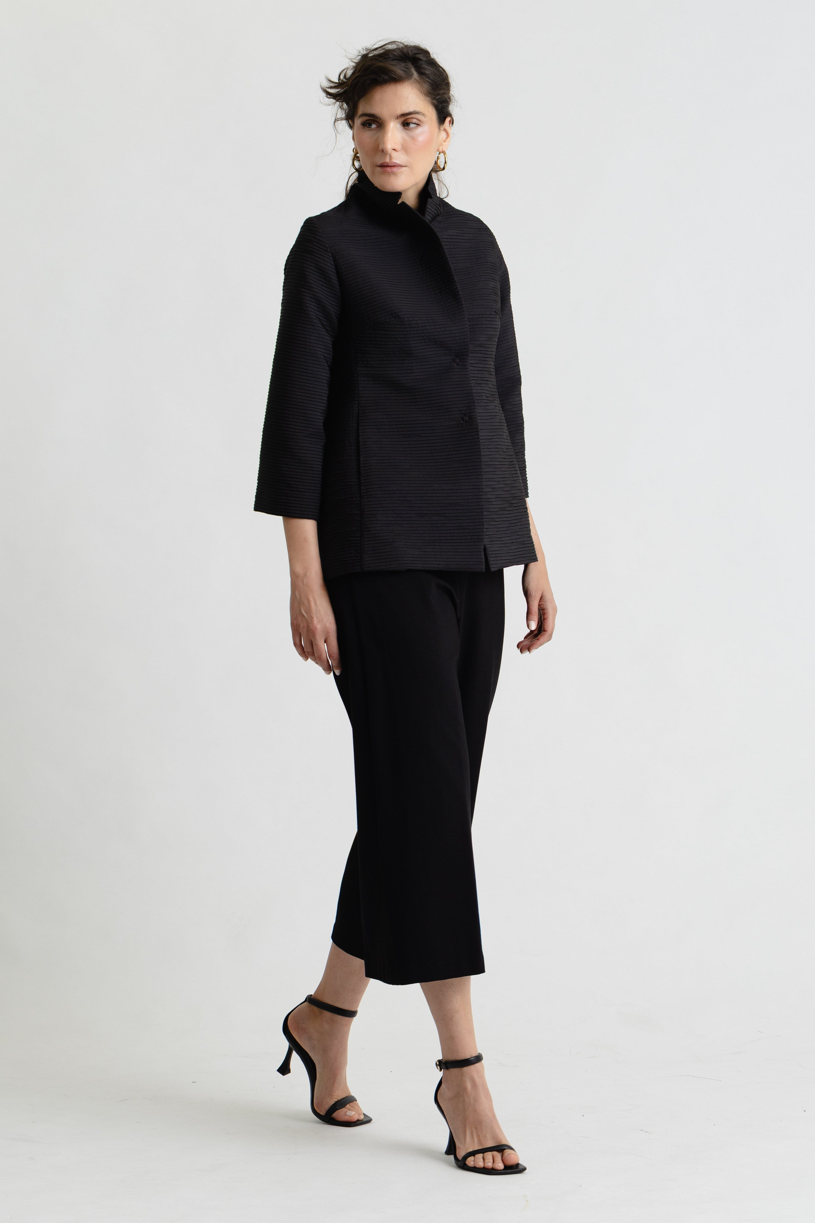 Woman wearing a black outfit on a white background