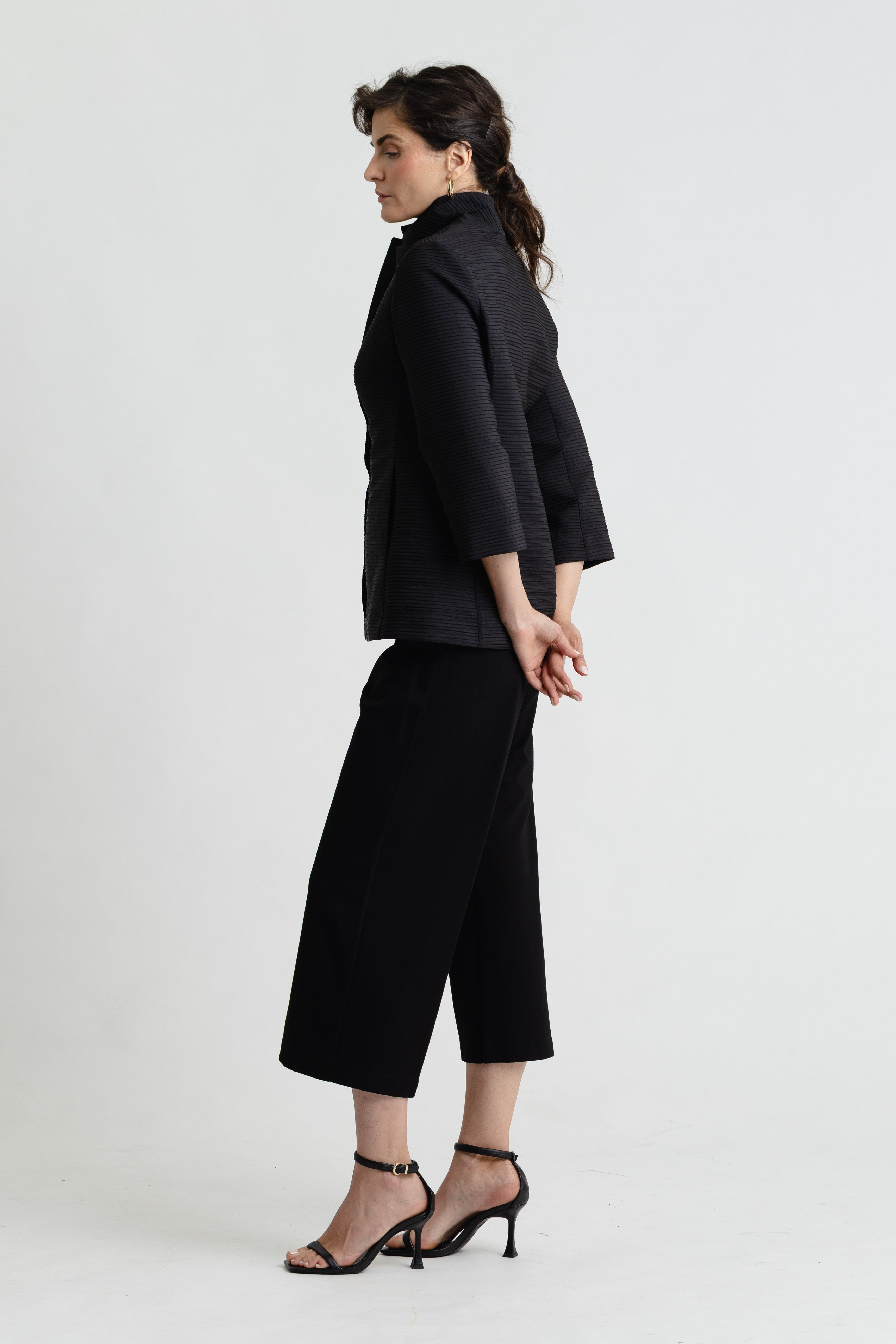 Person wearing a black outfit on a white background