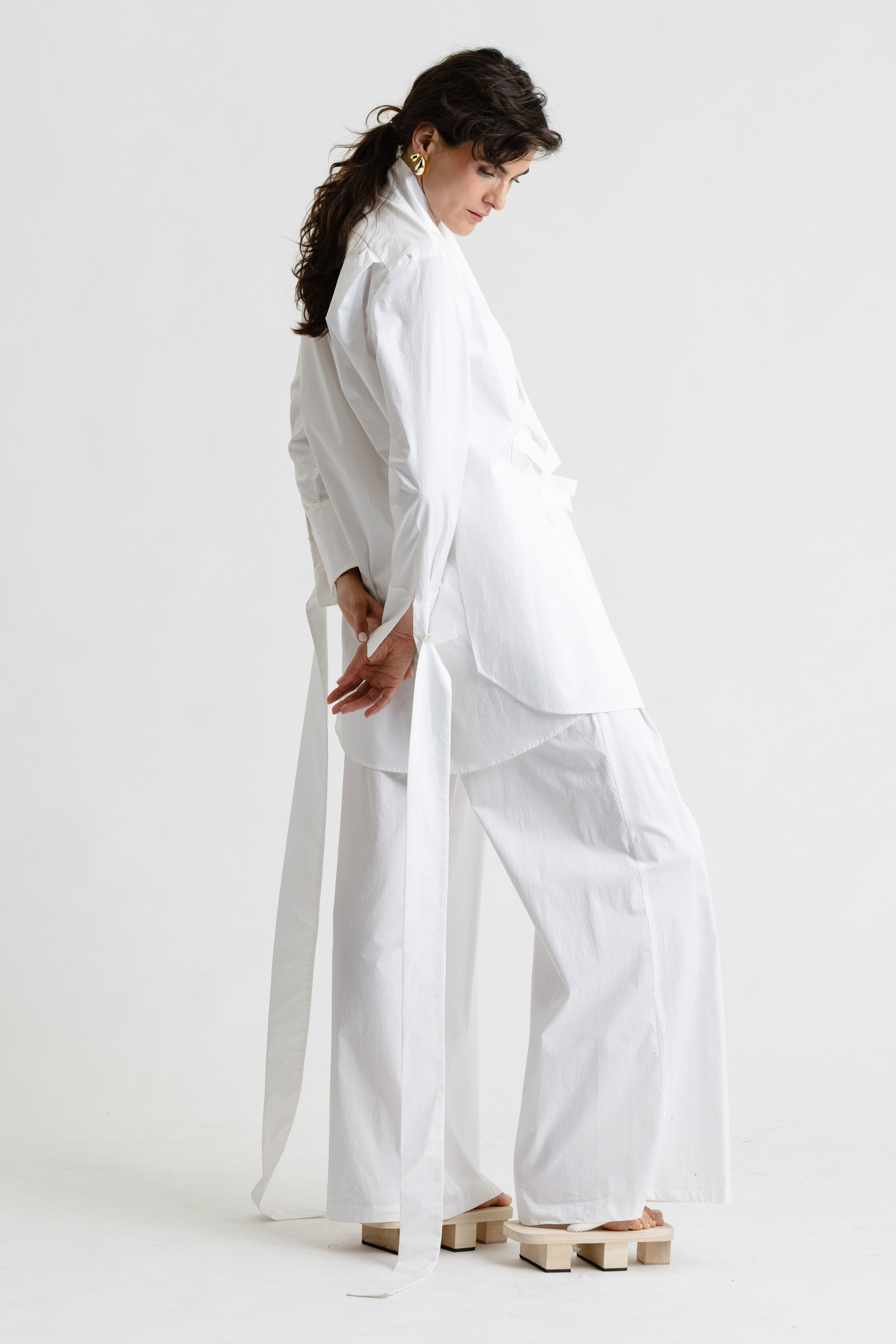 Person wearing a white outfit on a white background