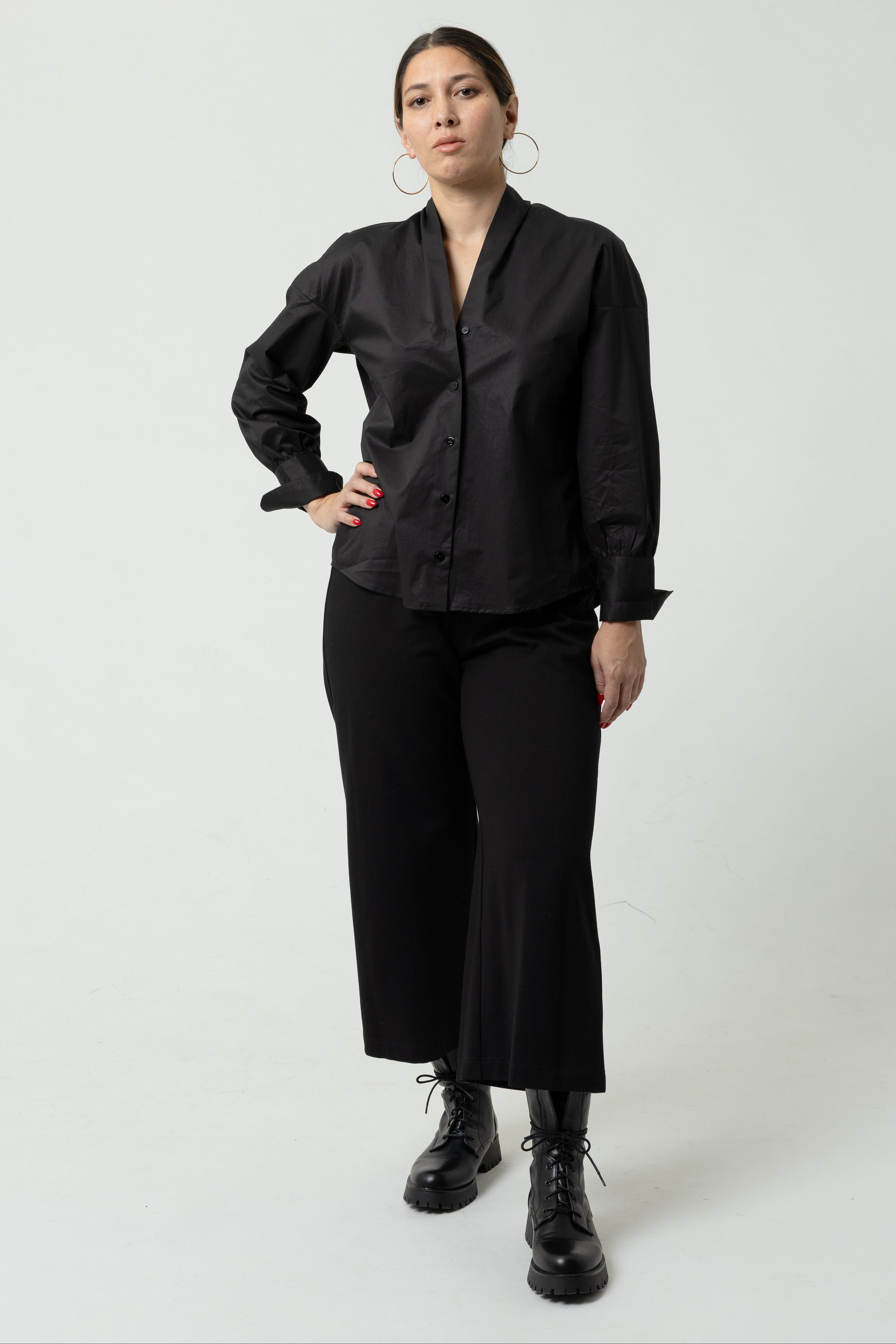 Person wearing a black outfit on a white background