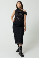 Woman wearing a black lace dress on a white background