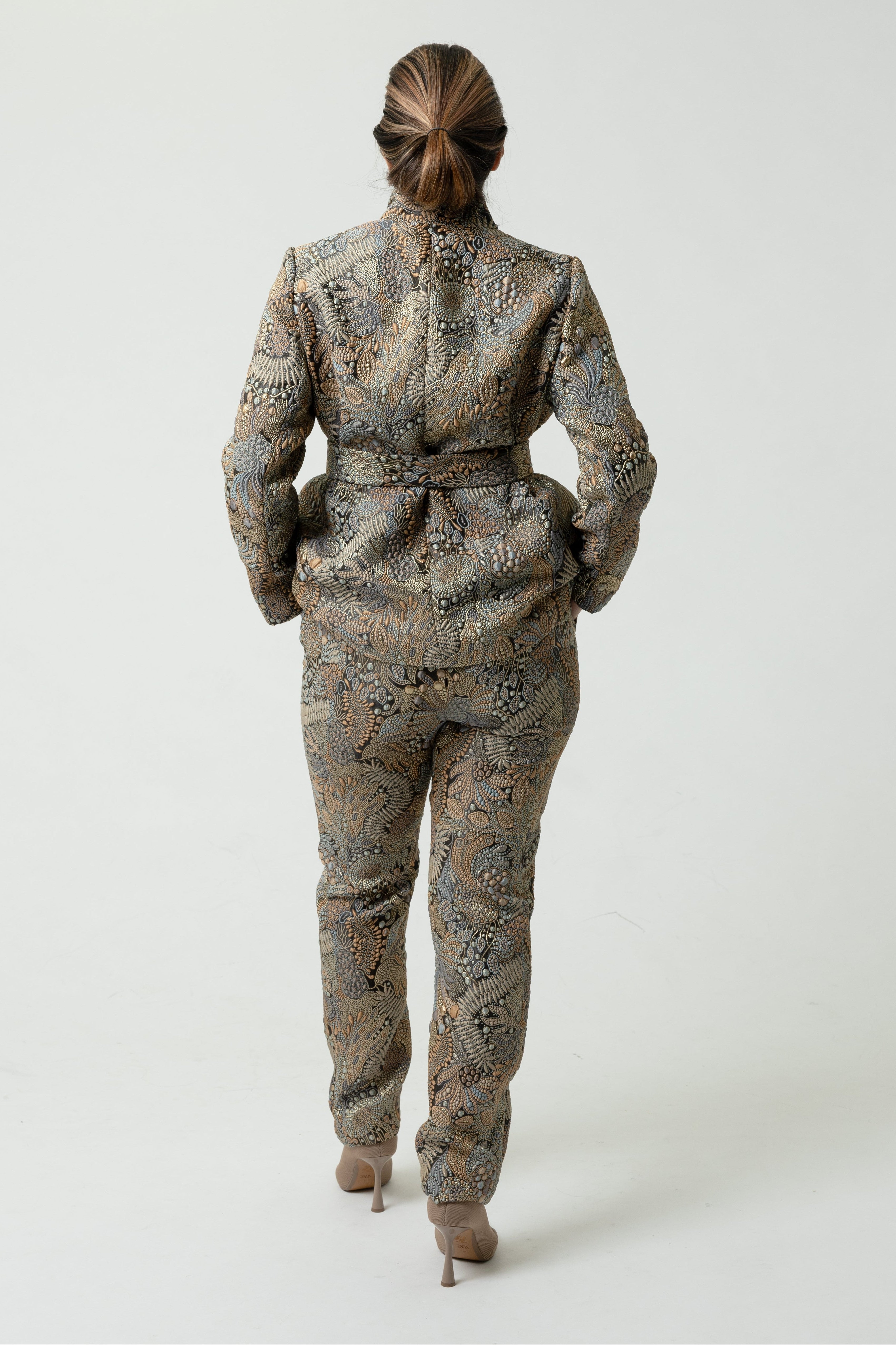 Person wearing a patterned suit on a white background
