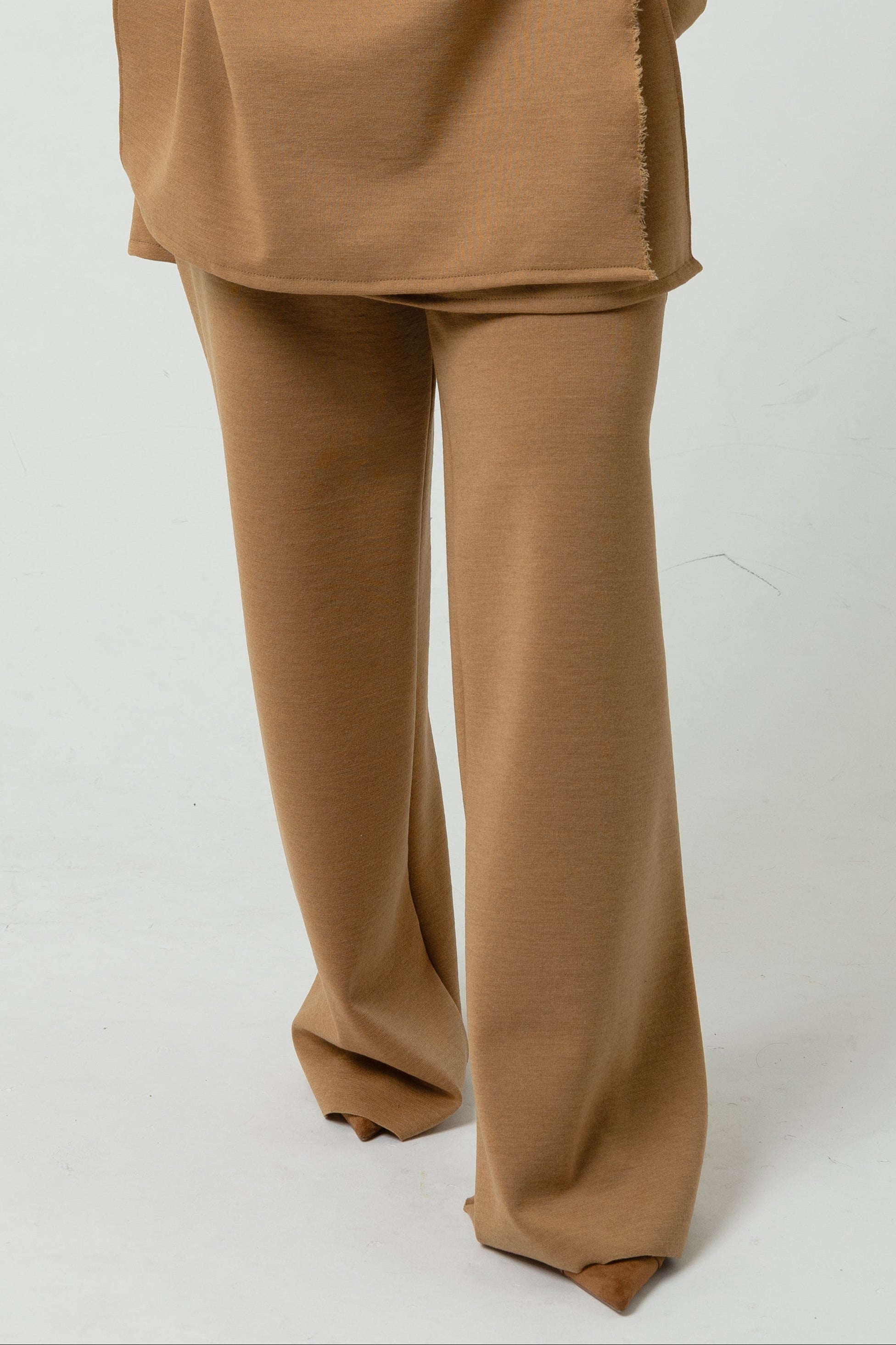 Woman wearing a beige outfit on a white background