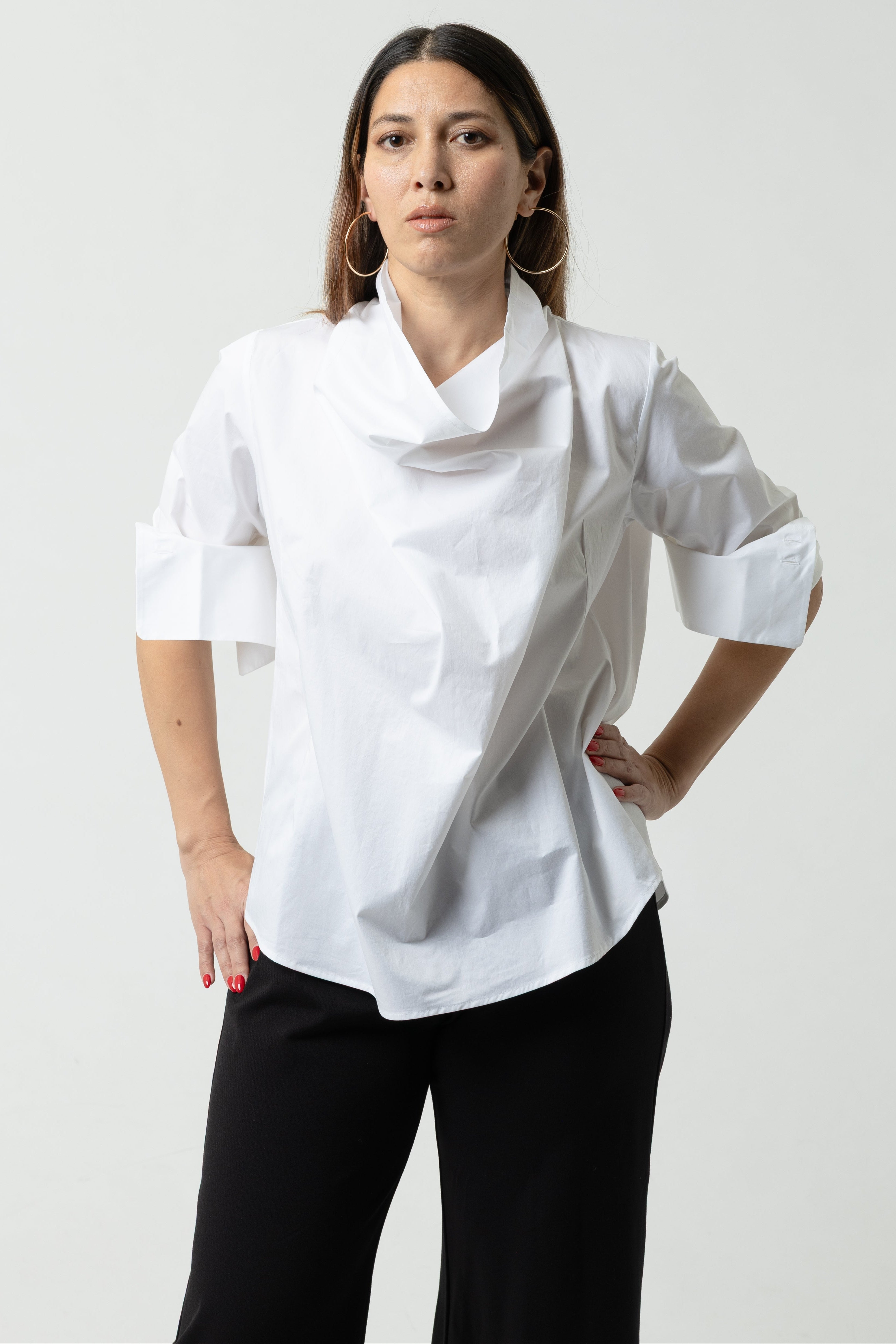 Person wearing a white chef's coat on a plain background