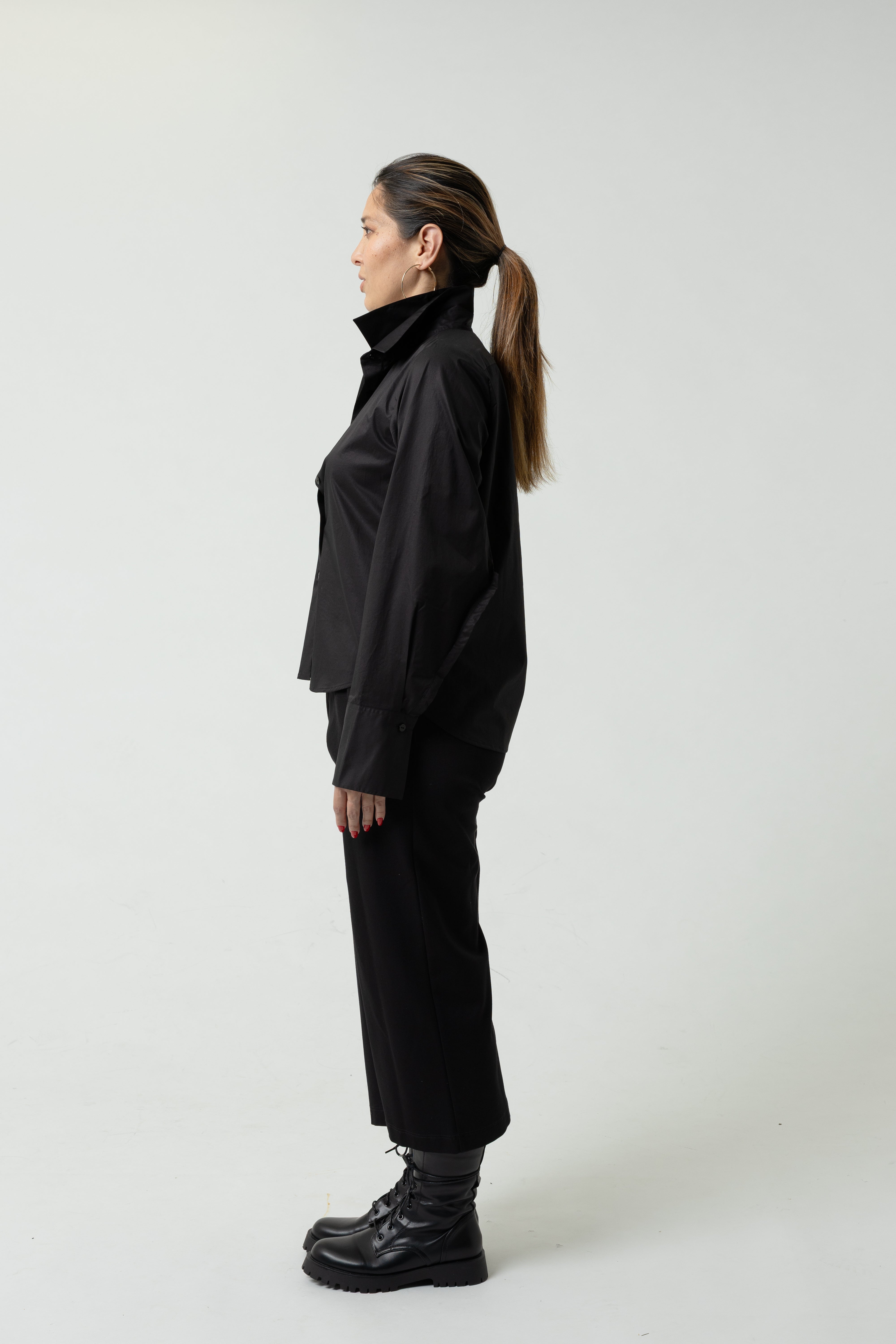 Person wearing a black outfit on a white background