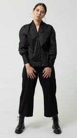 Person wearing a black outfit on a white background