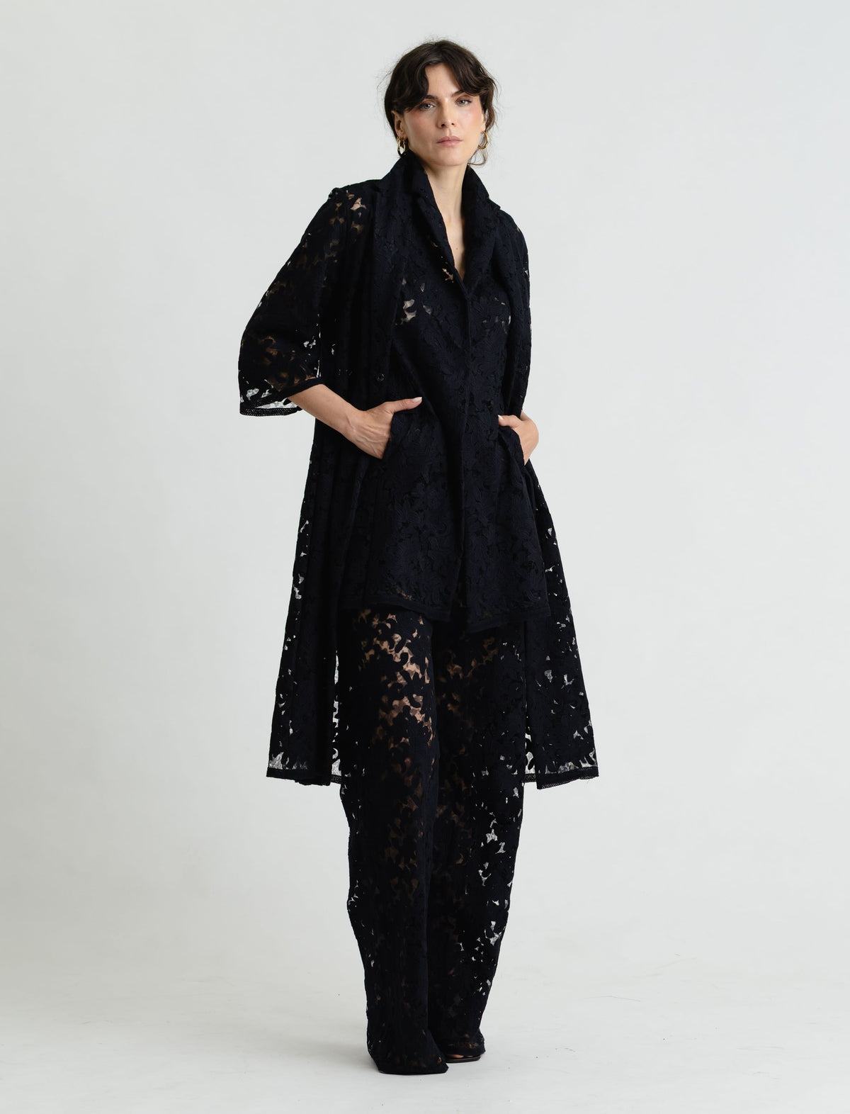Woman wearing a black lace outfit on a white background